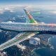 A commercial aircraft in flight with a transparent wing revealing embedded nano-piezoelectric sensors integrated into its composite structure, illustrating AI-enabled structural health monitoring and predictive aircraft maintenance.