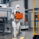 Apptronik Apollo humanoid robot carrying an industrial tote in a manufacturing facility