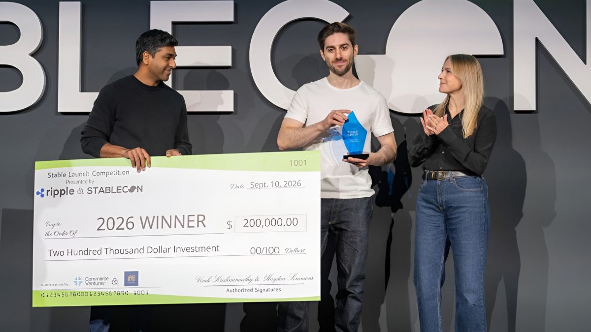 Walapay co-founder and CEO Tom Borgers holds the Stable Launch 2026 trophy beside a $200,000 winner’s check at Stablecon.