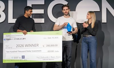 Walapay co-founder and CEO Tom Borgers holds the Stable Launch 2026 trophy beside a $200,000 winner’s check at Stablecon.