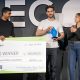 Walapay co-founder and CEO Tom Borgers holds the Stable Launch 2026 trophy beside a $200,000 winner’s check at Stablecon.